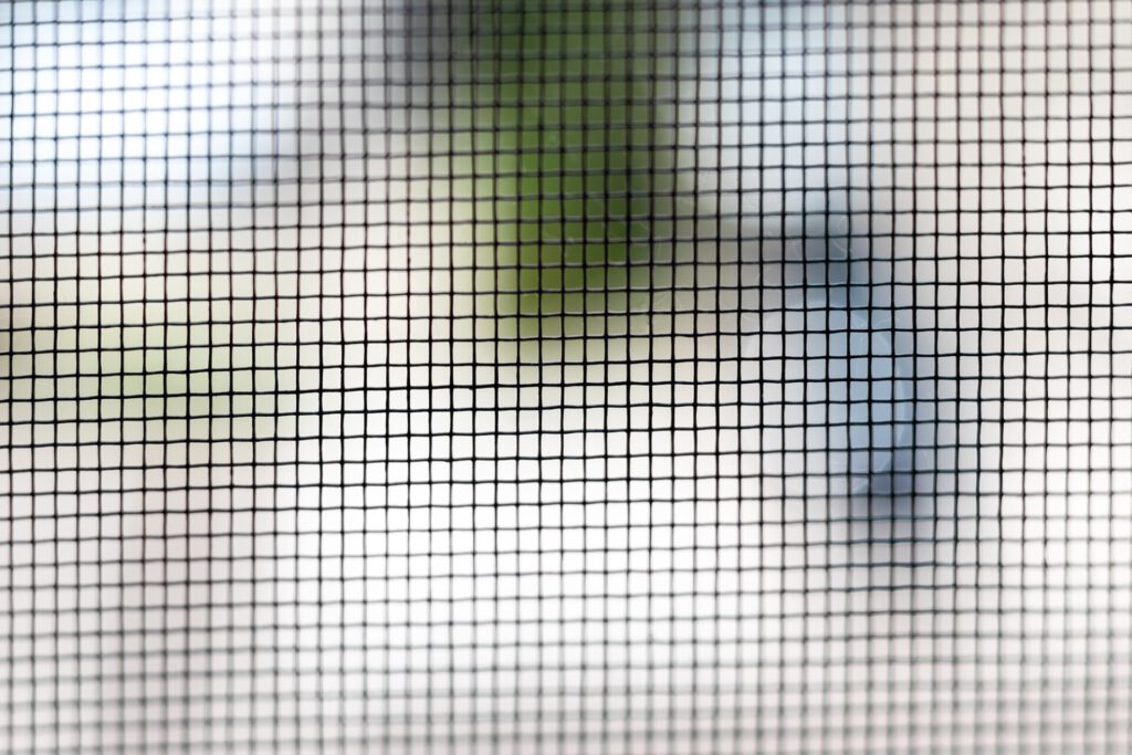 Mosquito net on the window closeup. Protection of the house from small insects